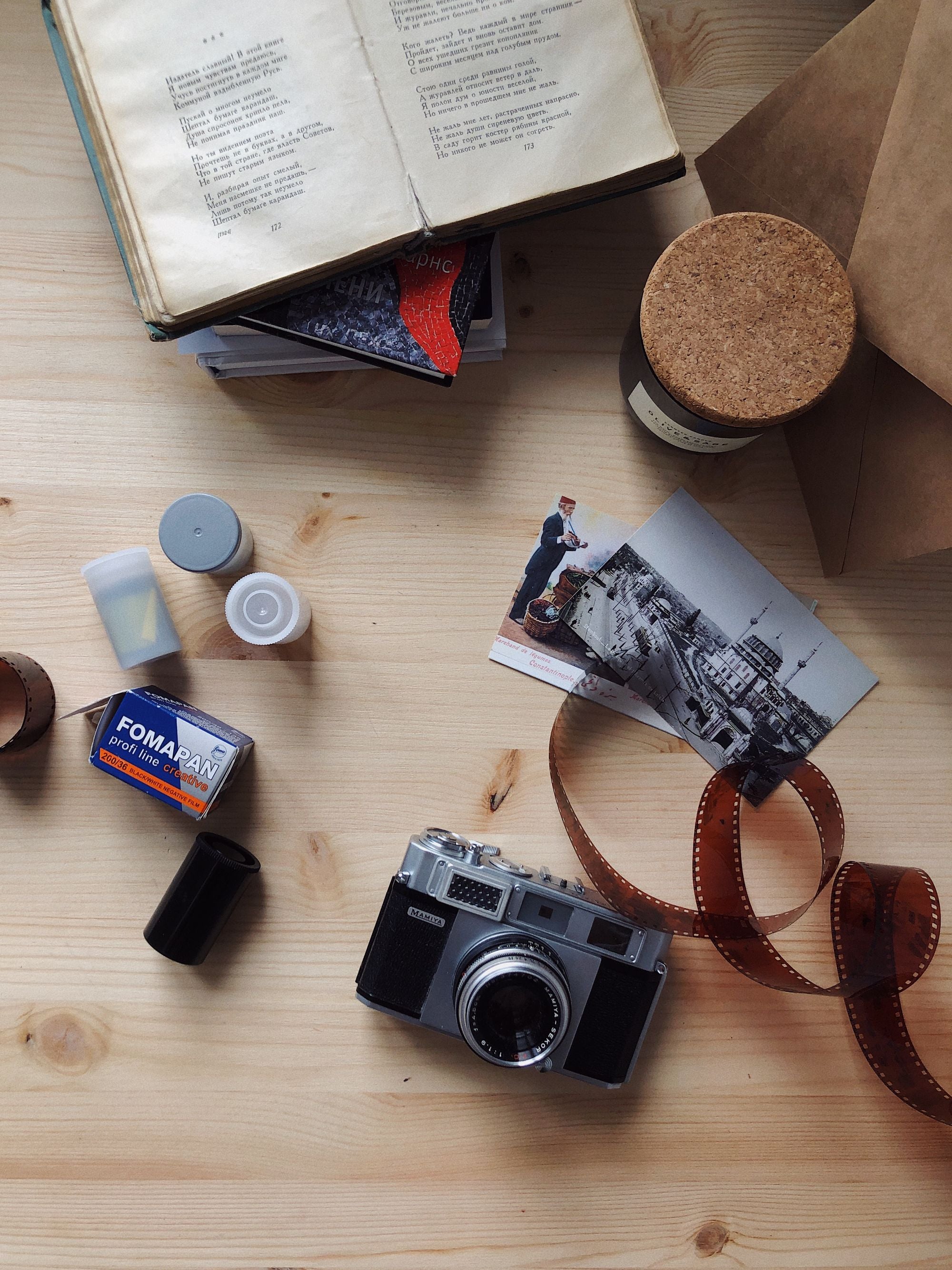 Vintage film camera and rolls of film on a wooden table
